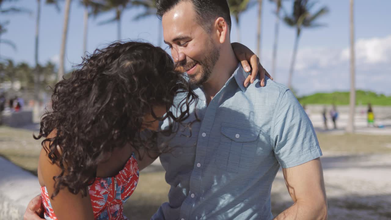Tender diverse couple having fun on beach