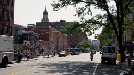 slow motion landscape of traffic streetlight intersection with pedestrian crossing city suburban street neighbourhood new york manhattan downtown brooklyn usa america travel