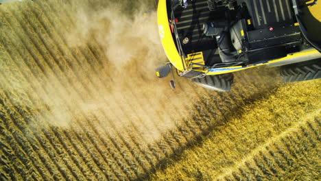 combine harvester deftly turns in farm land during crop harvest