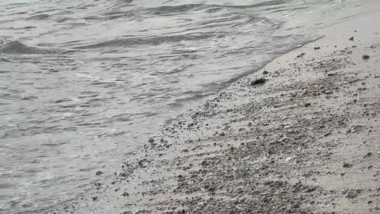 Gentle Waves Washing Over a Pebble Beach