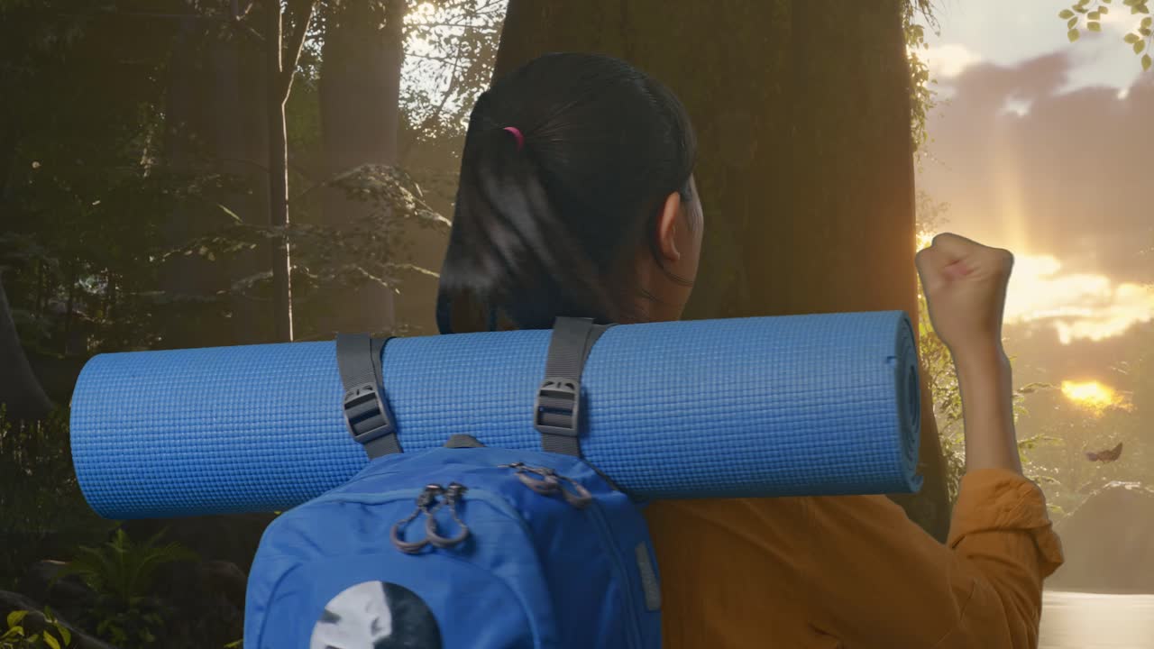 Primo piano, vista posteriore di un'escursionista con zaino da montagna che esulta per il successo mentre esplora la natura della foresta.