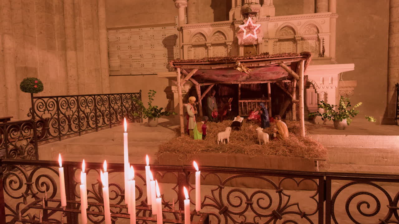 A serene nativity scene with candles in Church Saint-Nicolas, Blois, France