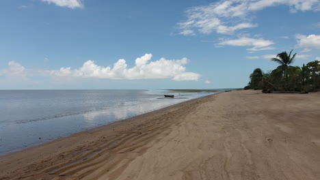 Vuelo-Hacia-Una-Canoa-En-Una-Playa-En-La-Aldea-De-Awala-Yalimapo,-Guayana