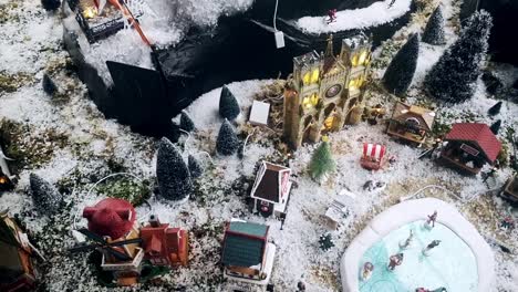 Picturesque-snowy-Christmas-model-toy-town-aerial-view-above-scenic-display-dolly-right