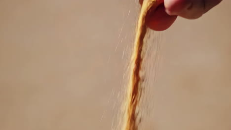 hand pouring sand