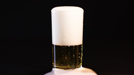 beer glass filling with foam rising