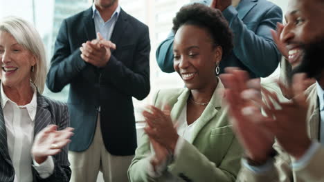 group of diverse business people clapping and cheering in office