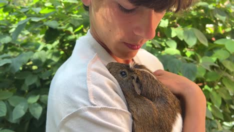 teenager holding a guinea pig