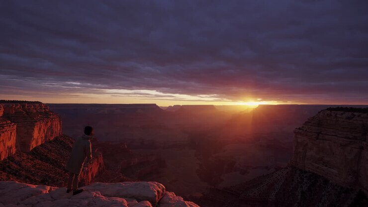Person Overlooking the Grand Canyon at Sunset