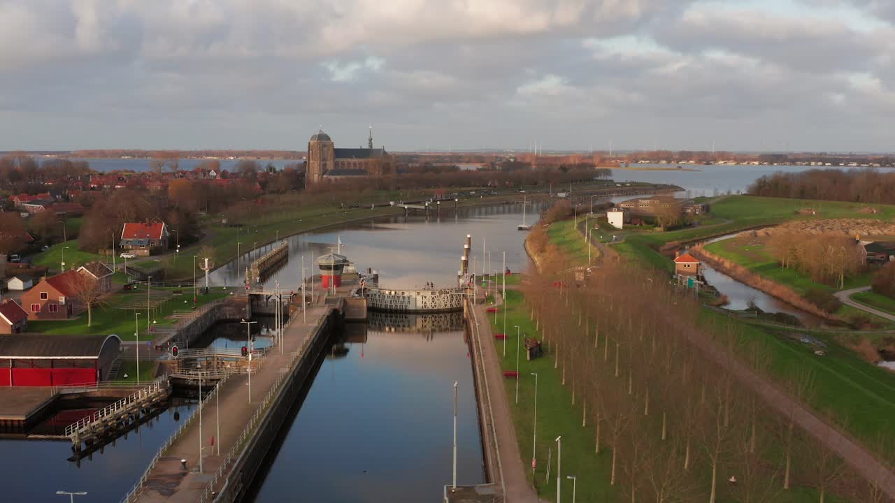 Locks in a canal with in the background the historical city Veere. Drone shot
