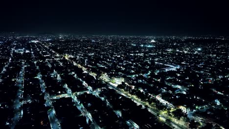 crane shot of mexico city at night time, residential area view