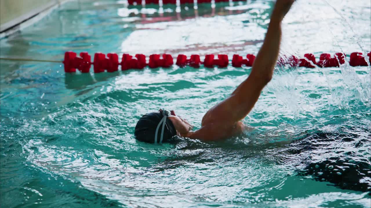 Dynamic Swimming Techniques: A Competitive Swimmer Demonstrates Efficient Stroke in a Pool Setting with Energy and Focus on Mastery