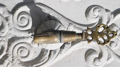 ornate water faucet on a decorated wall