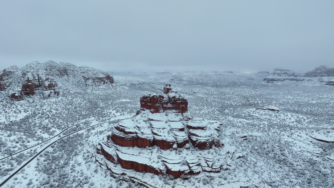 Snow-Covered Bell Rock, Sedona Arizona USA In Wintertime. Aerial Drone Shot