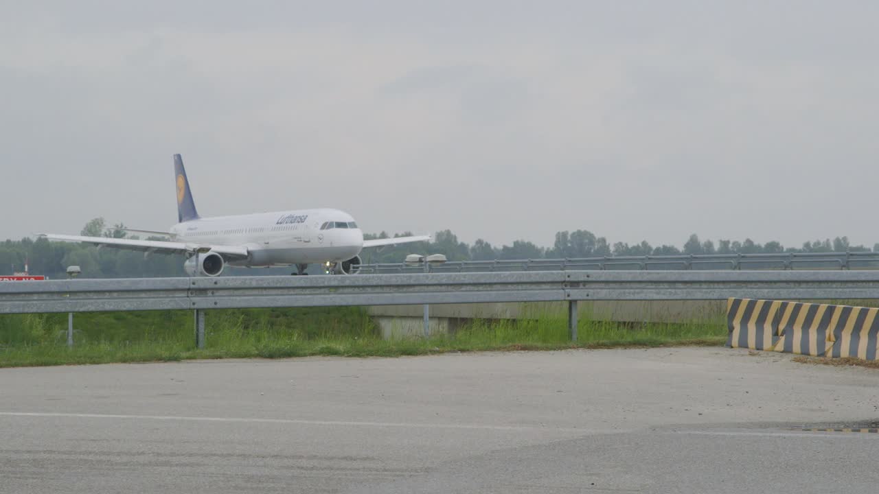 Medium wide shot of an Lufthansa airplane on the airfield at Munich airport after the lockdown due to corona crisis.