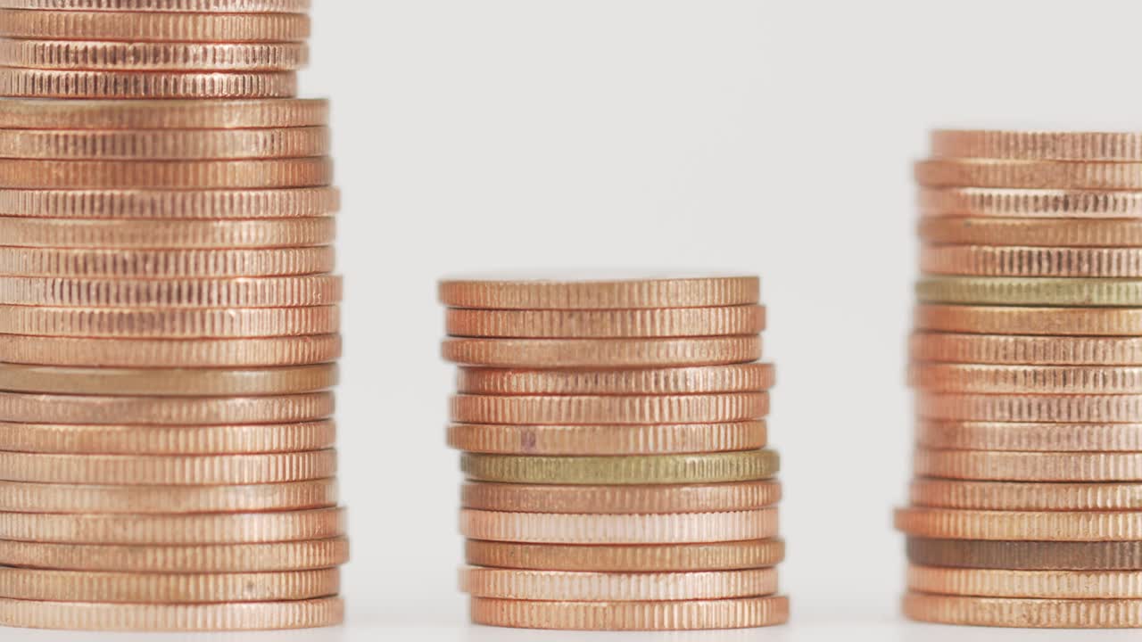 el dedo recoge una moneda de la pila.