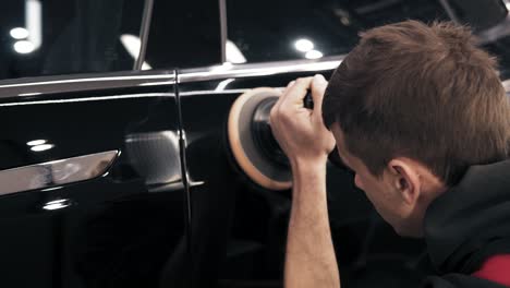 Process-of-accurate-polishing-of-a-black-new-car.