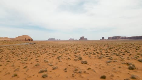 Monument-Valley-Highway-163-Aerial-Shot-Forward-Navajo-Nation-Southwest-Desert-Arizona-Utah-USA