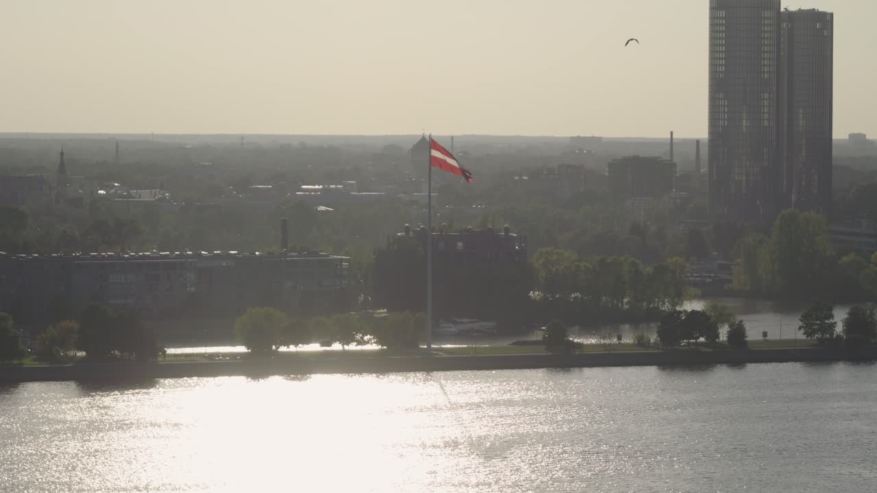 Danish Flag Flying Over Copenhagen Skyline at Sunset