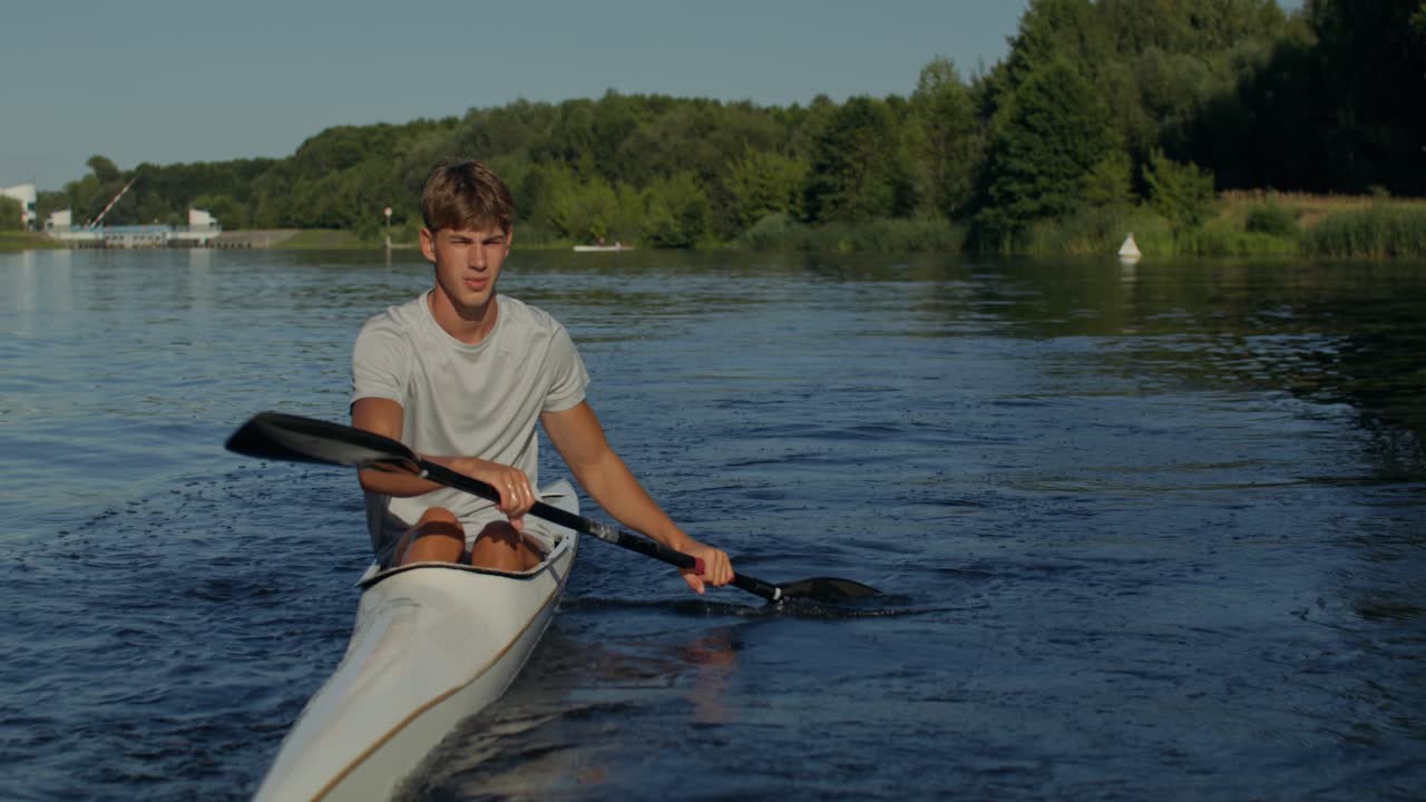 Man Kayaking on a Lake