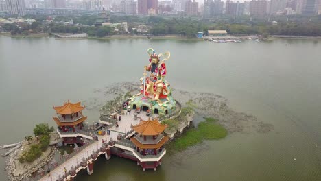 drone shot of tourist on the bridge of zuoying yuandi temple at lotus pond in kaohsiung, taiwan.