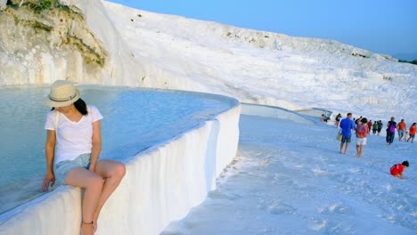 pamukkale, natural site in denizli province in southwestern turkey. tourist young woman spends her holiday in pamukkale.