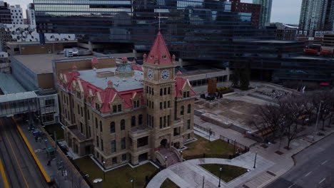 aerial shot moving down of calgary city hall