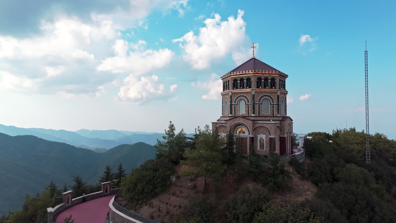 Archbishop makarios iii tomb surrounded by lush mountains on a sunny day, aerial view