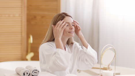 woman's morning skincare routine in a bright bathroom
