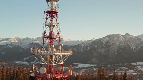 zakopane-gubalowka transmitter tower with snowy mountain in background at zakopane, poland