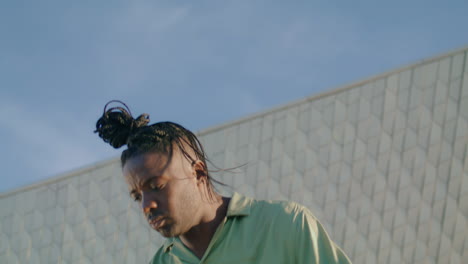 gorgeous guy dancing contemp in modern wall closeup. man expressing emotions