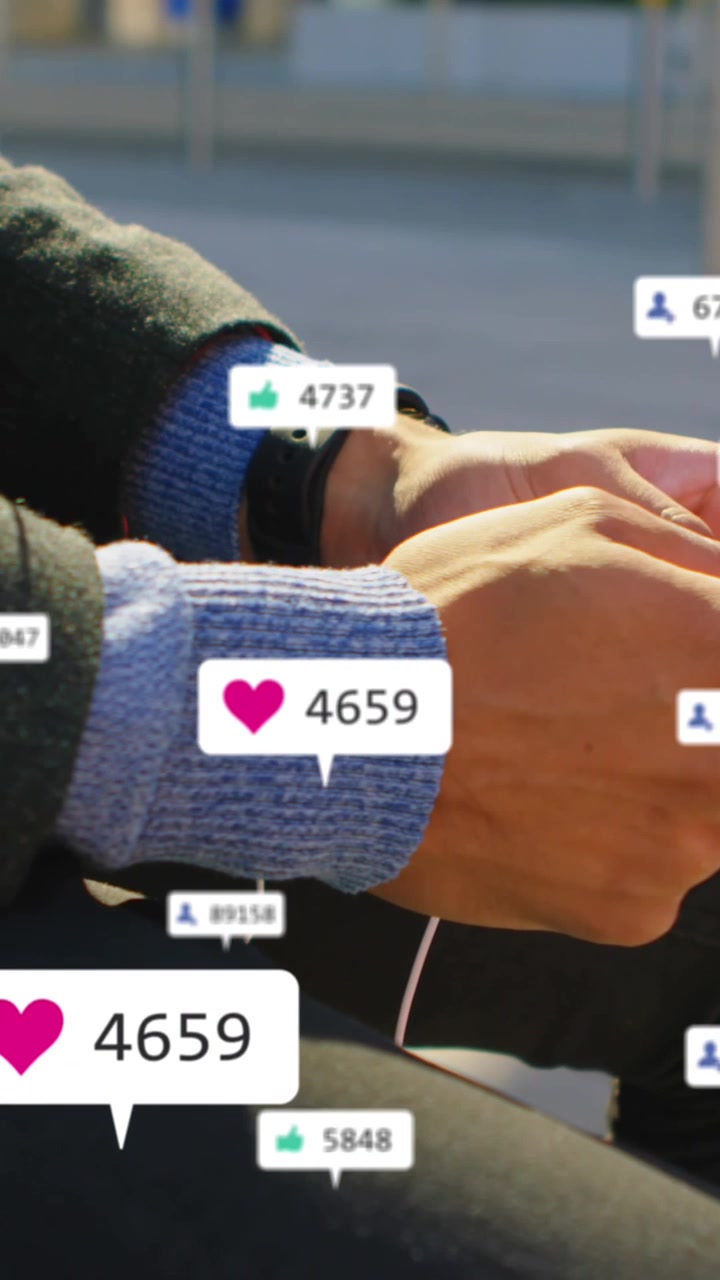 Animation of social media icons and numbers on banners over man using smartphone
