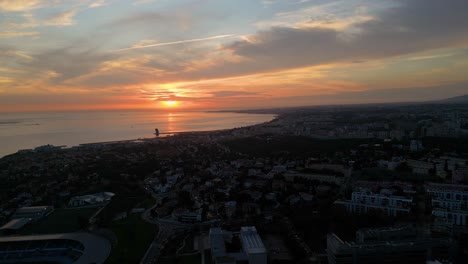 vista aérea de un tranquilo amanecer sobre la ciudad, con el sol proyectando su cálido resplandor en la superficie del agua, creando una escena serena y pintoresca
