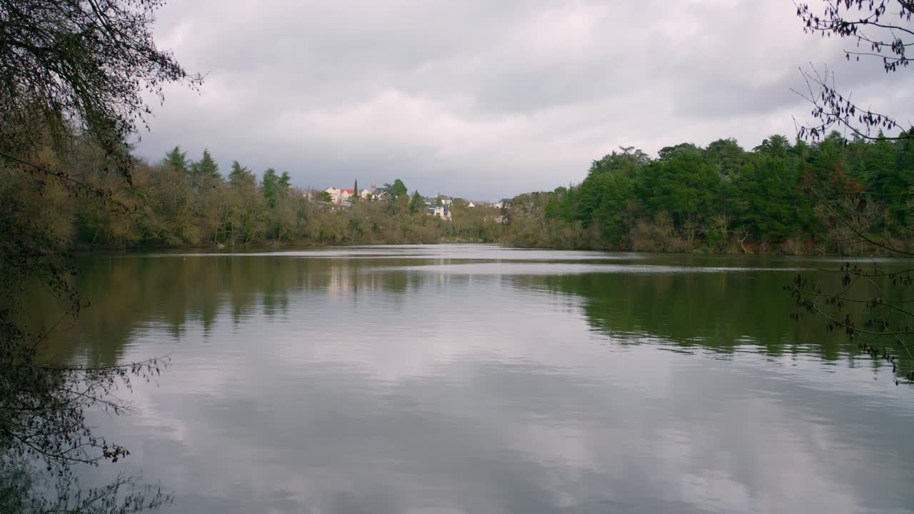 спокойное озеро с зеркальным отражением в анжерсе, франция в облачный день
