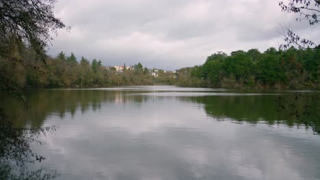 Calm-Lake-With-Mirror-Reflections-In-Angers,-France-During-Cloudy-Day