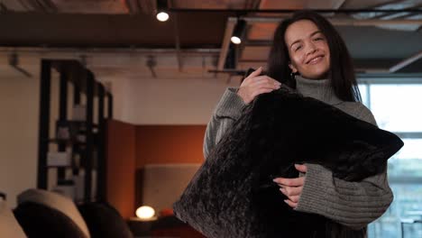 attractive female customer holds black pillow in furniture store attractive female customer holds black pillow in furniture store high quality footage