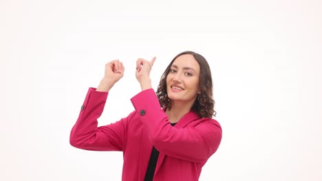 smiling woman in pink blazer pointing upwards on white background