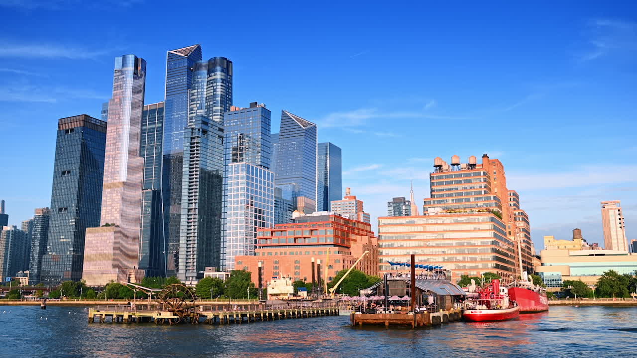 New York, USA, 4 August 2025: Manhattan skyscrapers and Frying Pan ship at Hudson River. View of Manhattan skyscrapers with the historic Frying Pan ship docked