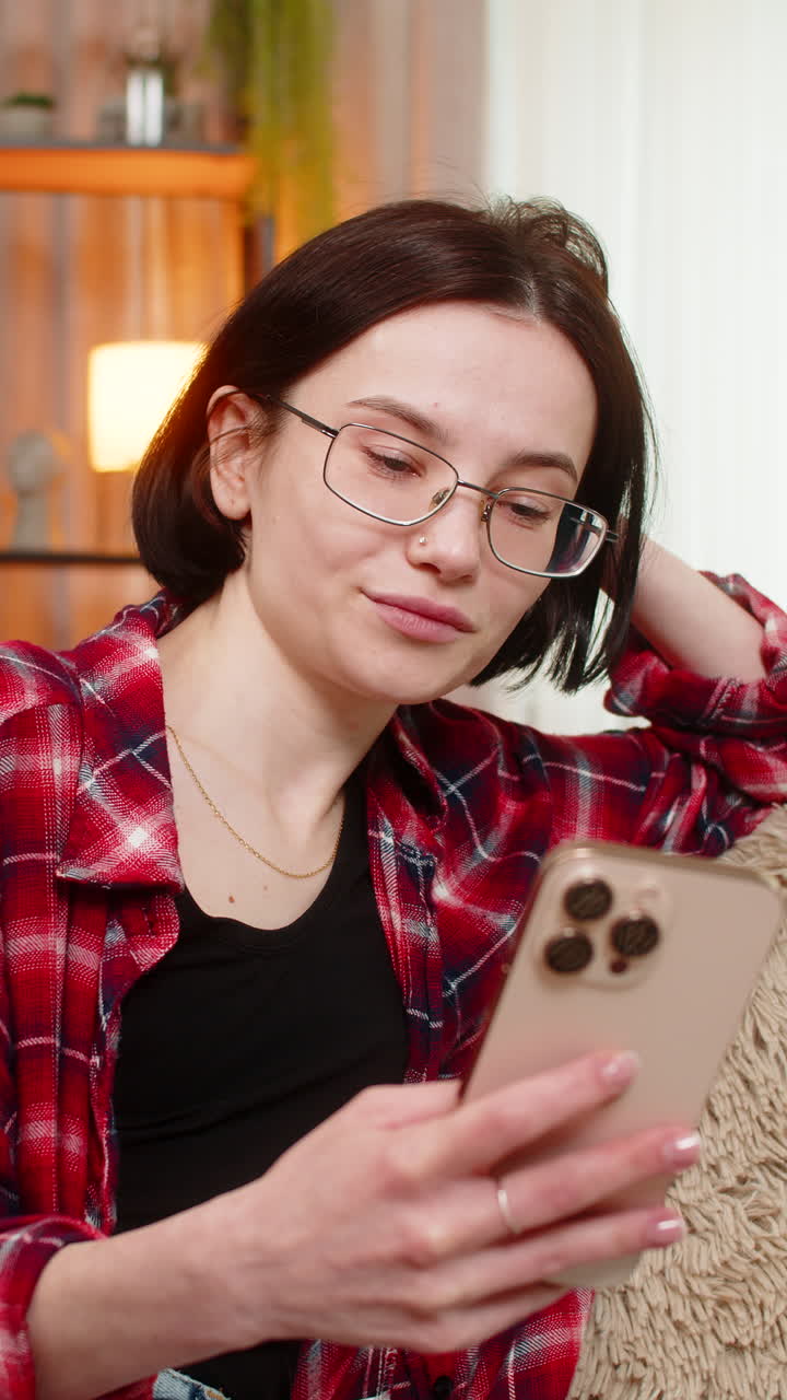 Woman browsing travel photos on smartphone smiling with joy while remembering vacation memories