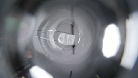 ice cube falling into glass and covering camera lens close up worms eye view