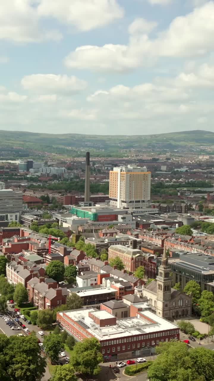 Reversing social ratio aerial of Belfast City Hospital on a bright and sunny day. Produced in 1080x1920, 60fps and with Rec709 color