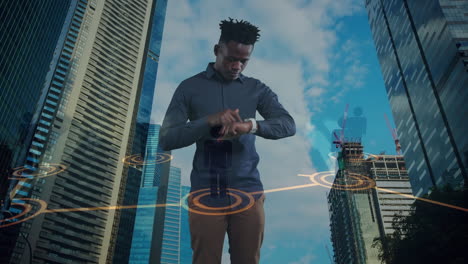 animation of african american businessman using smartwatch over cityscape