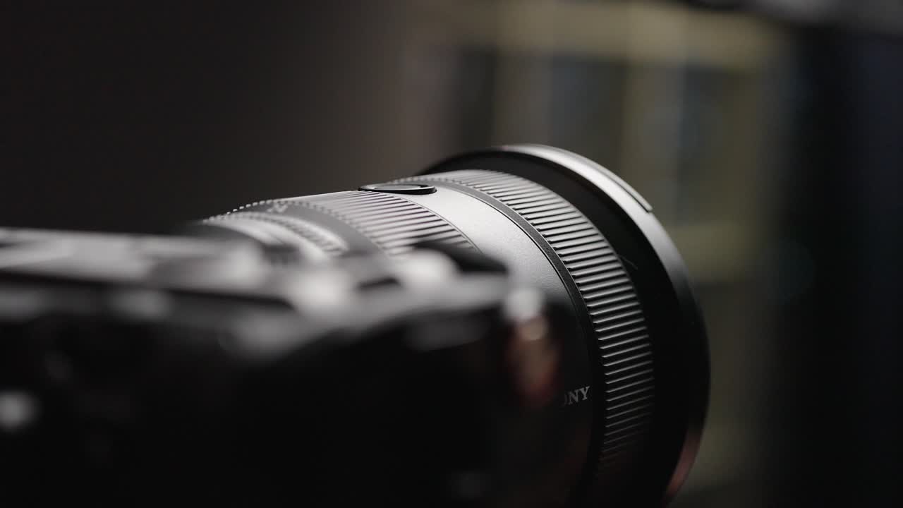 Close-up of a professional camera lens being adjusted
