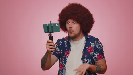 Man-blogger-take-selfie-on-mobile-phone-selfie-stick-communicate-video-call-online-with-subscribers