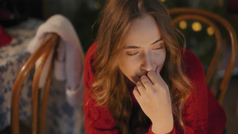 young woman thinking while sitting at home