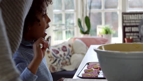 boy licking cake mixture from spoon shot on r3d