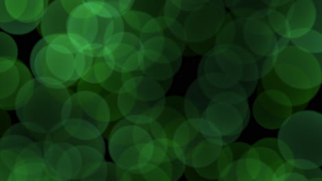 Flying-large-green-round-bokeh-on-black-gradient