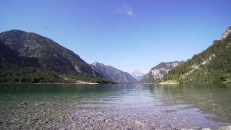 scenic view of lake plansee with mountains in background, austria