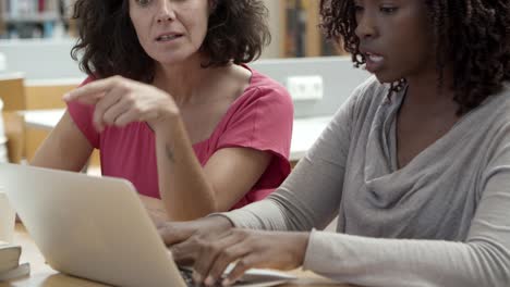 Closeup-shot-of-pensive-students-working-over-project-at-library