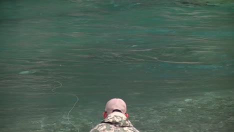 Trout-fly-fishing-in-mountain-river-at-summer